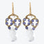 Elegant gold-toned drop earrings with blue gemstones and teardrop crystal.