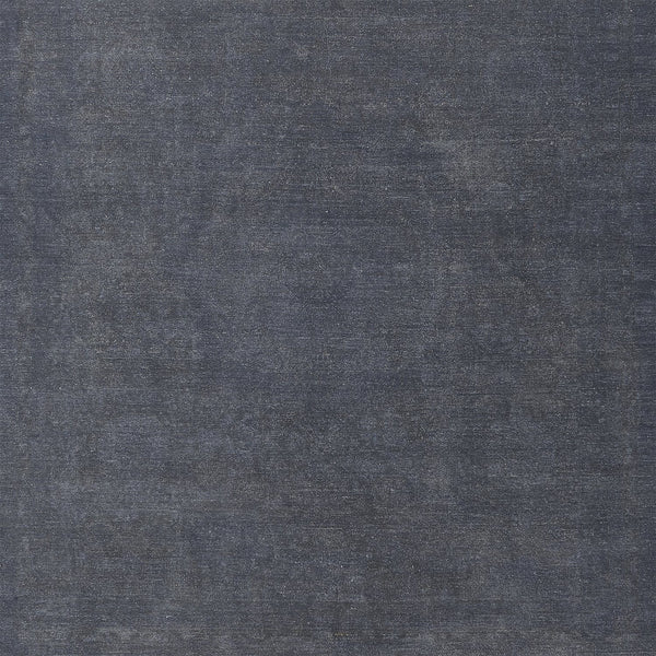 Close-up photograph of dark blue fabric with denim-like texture.
