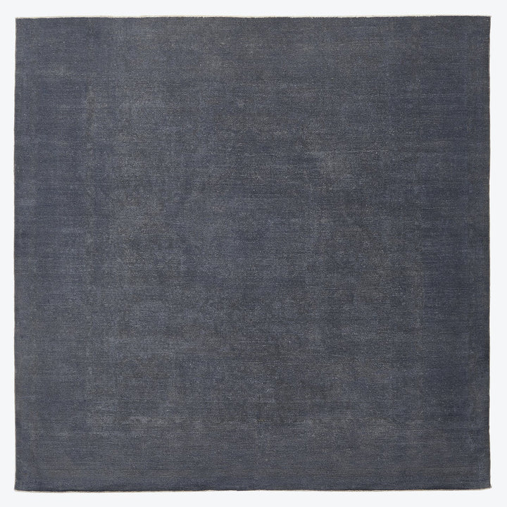 Minimalist navy textile with coarse natural fiber texture fills frame.