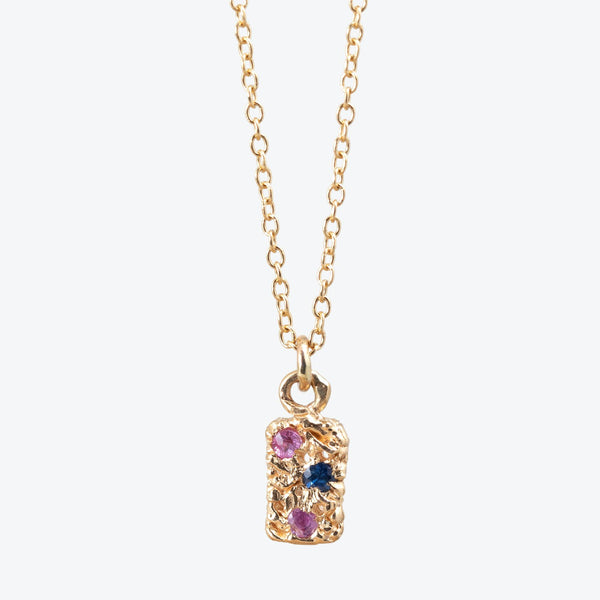 Handcrafted gold necklace with colorful gemstone pendant for a vibrant touch.
