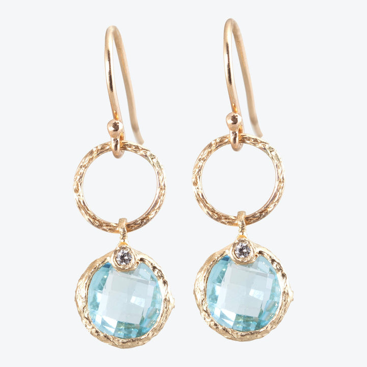 Elegant gold-tone earrings with blue gemstones and sparkling accents.