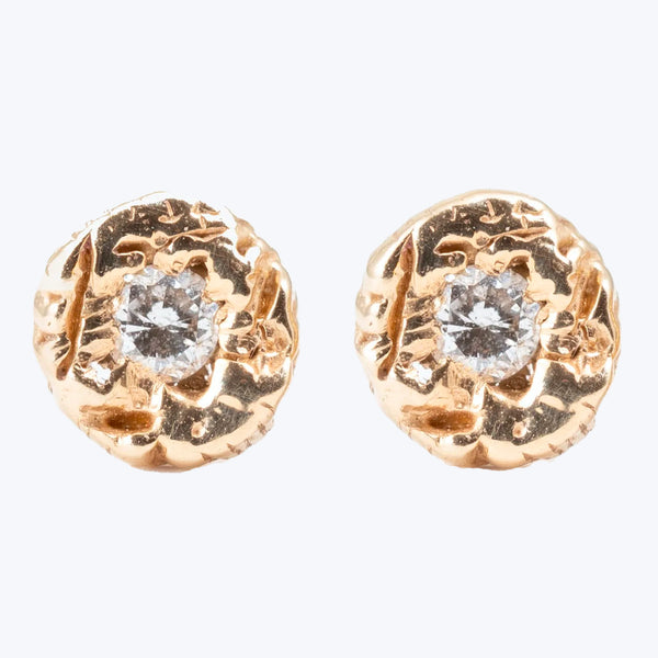 Gold-tone earrings with textured surface and faceted clear gemstones.