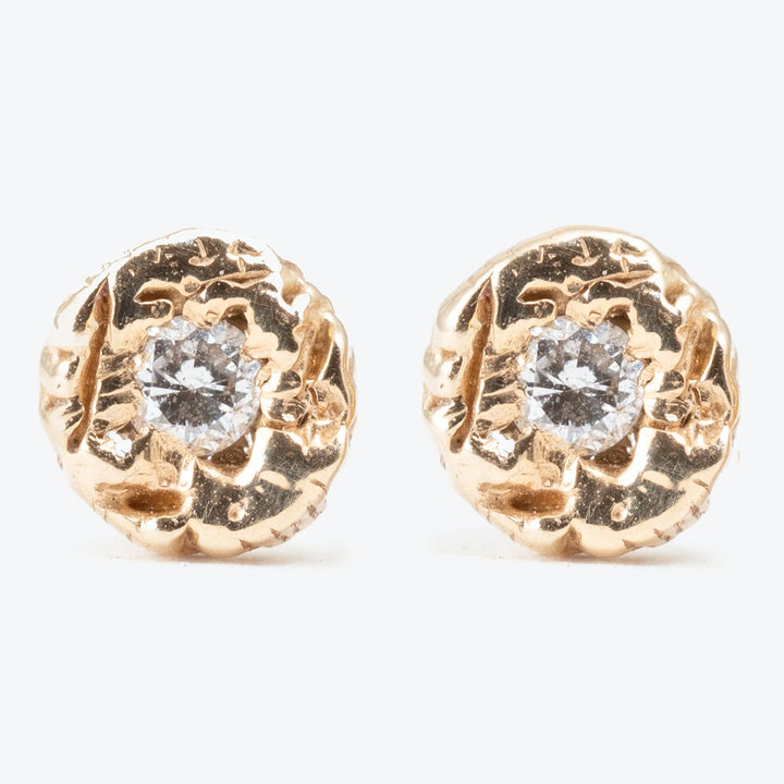 Elegant gold-tone earrings with clear faceted stones in organic design.