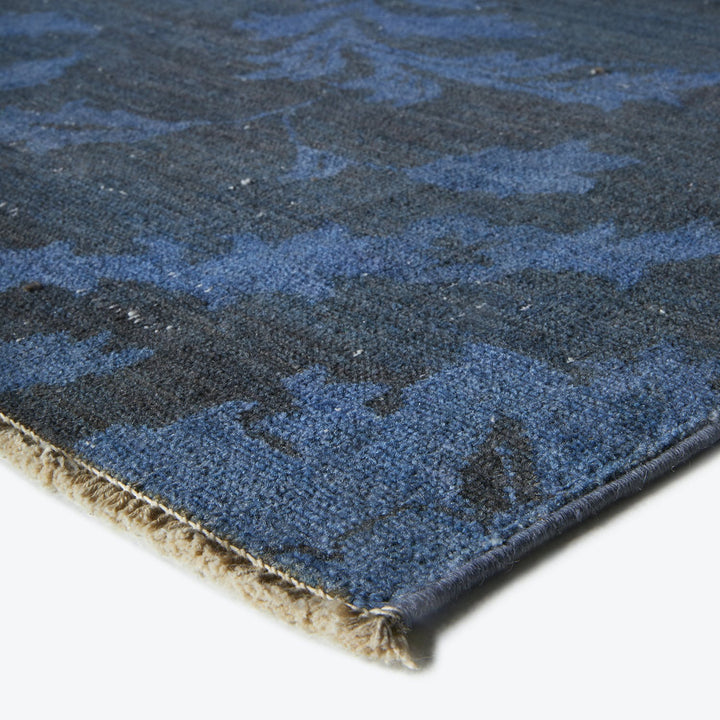 Thick and plush blue carpet with abstract organic design pattern.