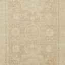 Intricate symmetrical pattern on neutral background evokes classical rug design.