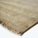 Close-up view of a textured beige rug with a grid pattern.