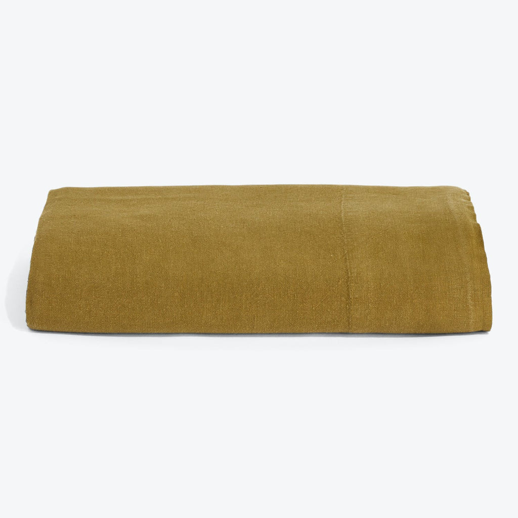 Neatly folded mustard-colored cotton towel against a clean white background.