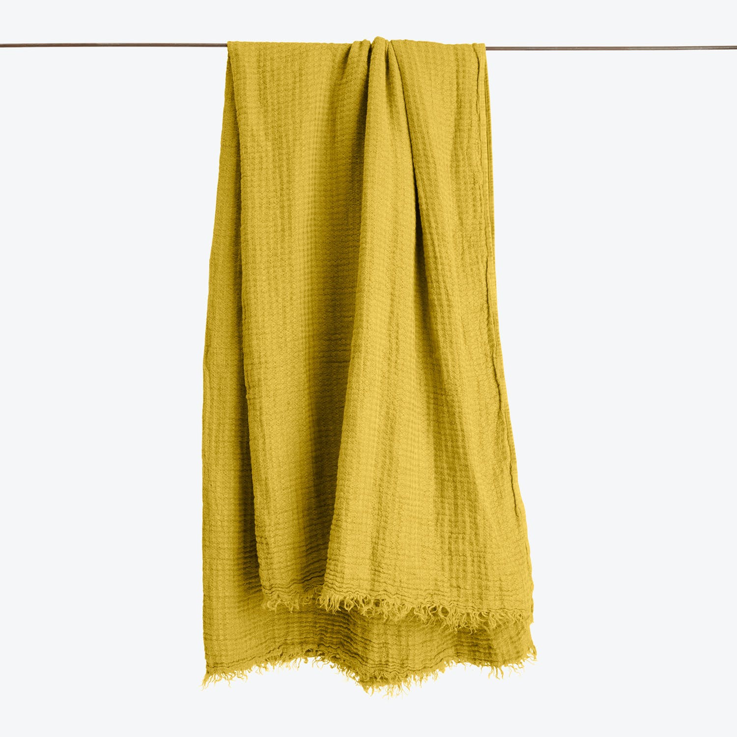Mustard yellow fabric with a loose weave and frayed edge.