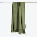 Green textured fabric with fringe displayed on white background