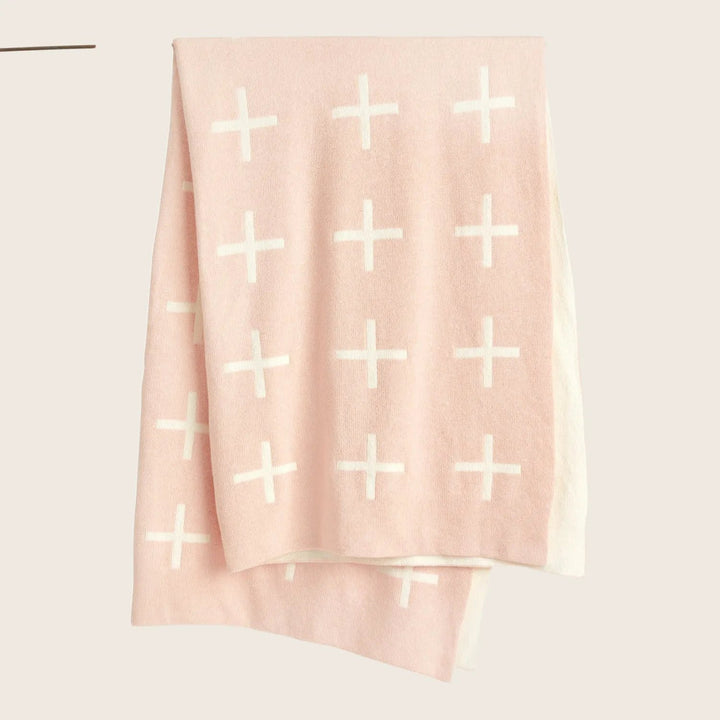 Pale pink textile with evenly distributed white plus signs pattern.