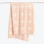 Pale pink textile with evenly distributed white plus signs pattern.