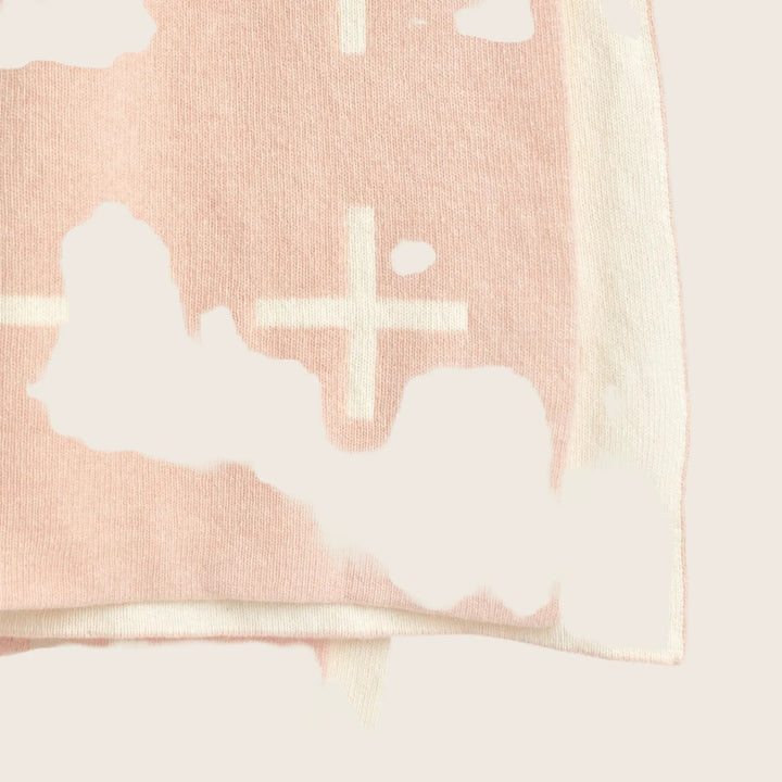 Pale pink fabric with delicate cross pattern, folded and lightweight.