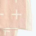 Pale pink fabric with delicate cross pattern, folded and lightweight.