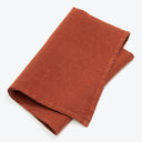 Terracotta-colored fabric with a soft texture against white background.