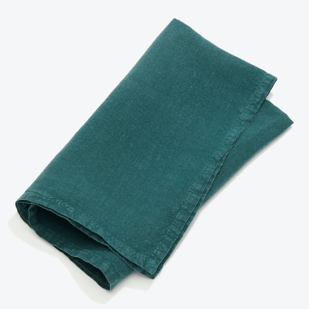 Neatly folded teal cloth napkin with visible soft texture.