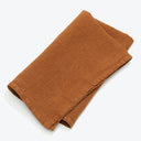 Neatly folded brown fabric with a soft suede-like texture.
