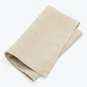 Folded linen/cotton cloth, light beige, durable, high-quality textile, ready for use.