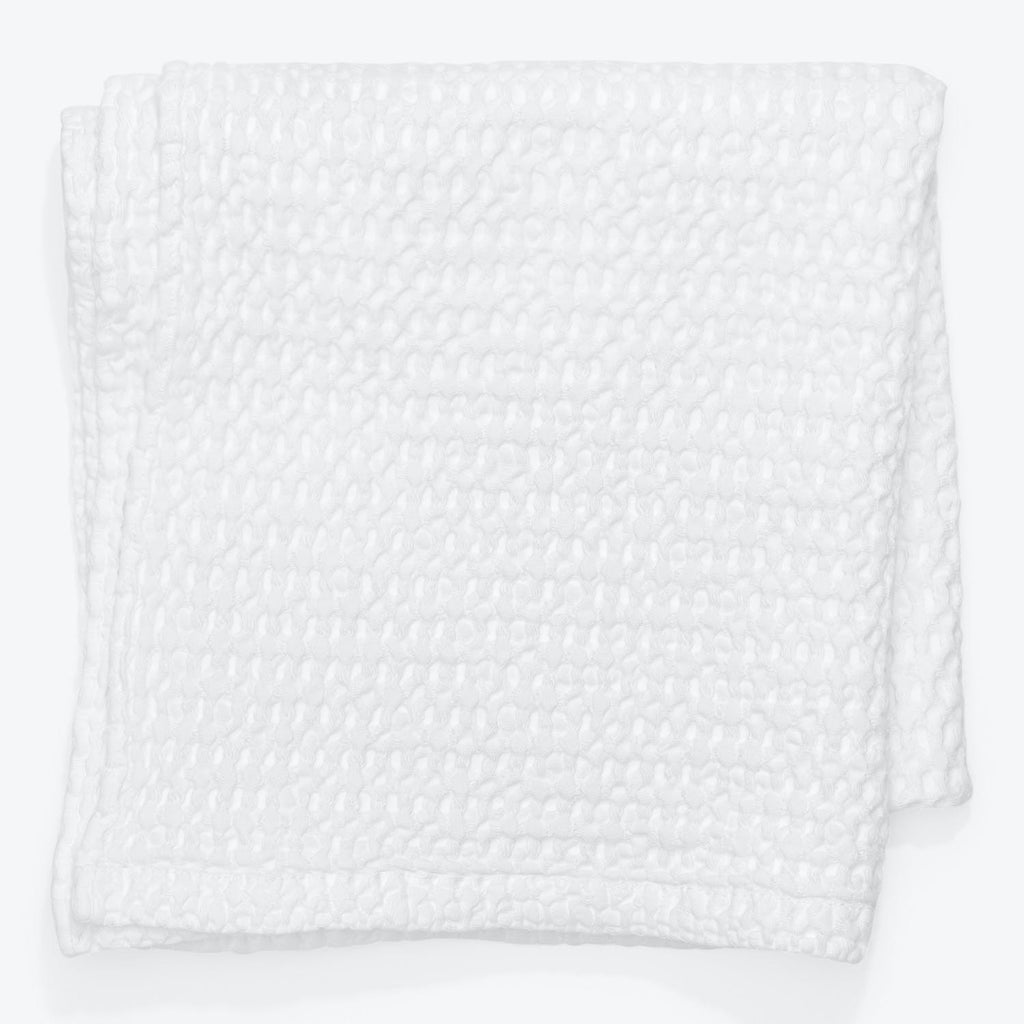 Neatly folded white blanket with bubbled texture, perfect for insulation.