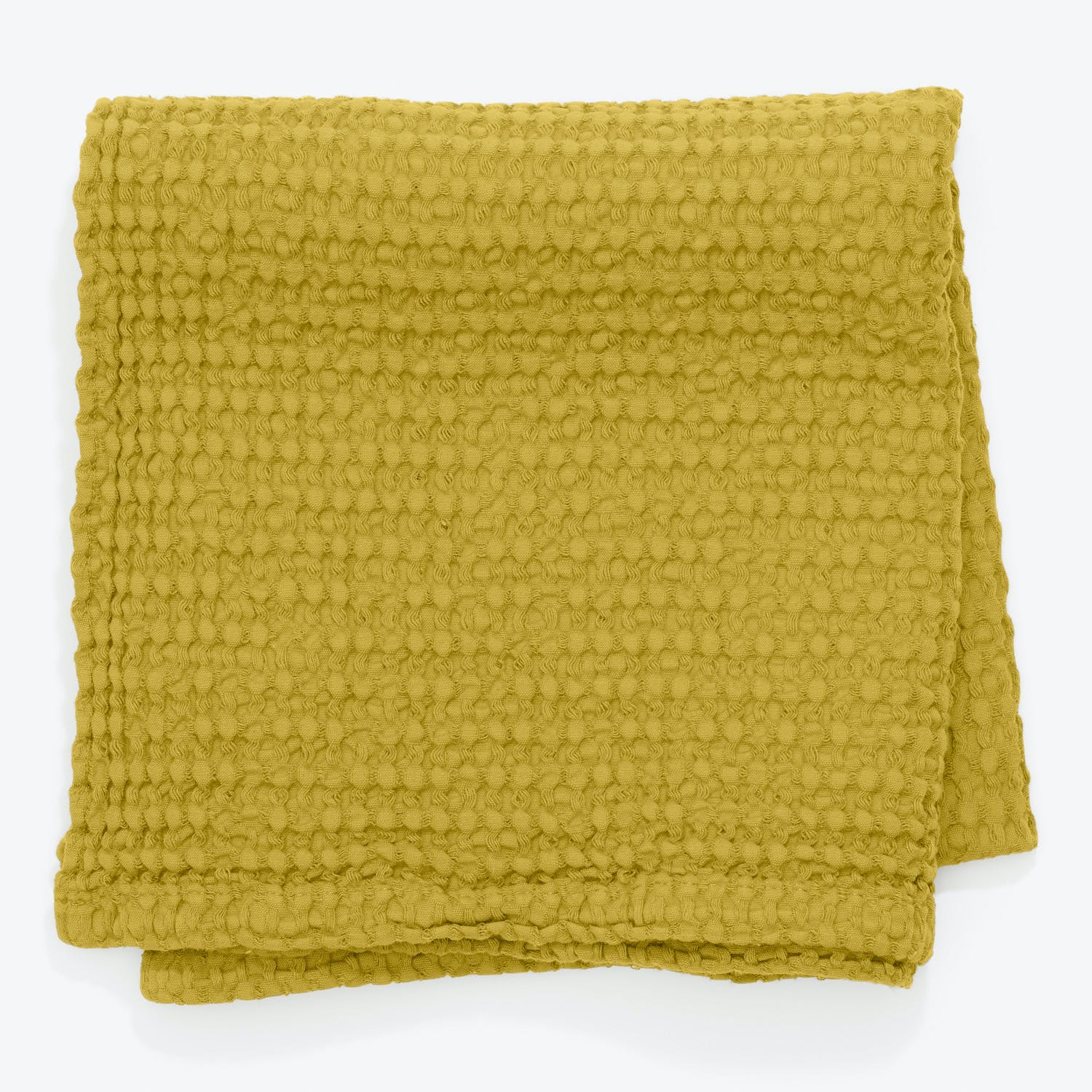 Vibrant green towel/blanket with soft, textured pattern on white background.