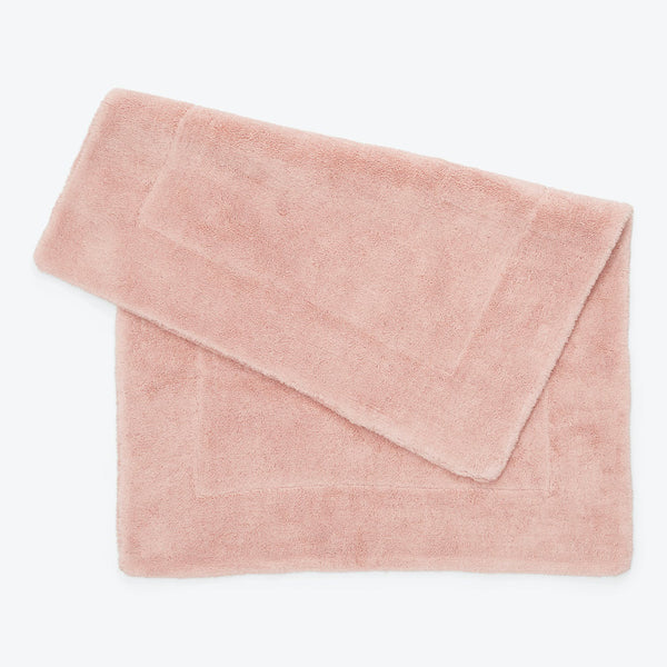 Soft and fluffy light pink towel with high absorbency.