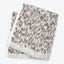 Plush towels in a mottled animal print pattern stacked neatly