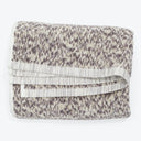 Soft and fluffy beige and brown towel with decorative patterning.