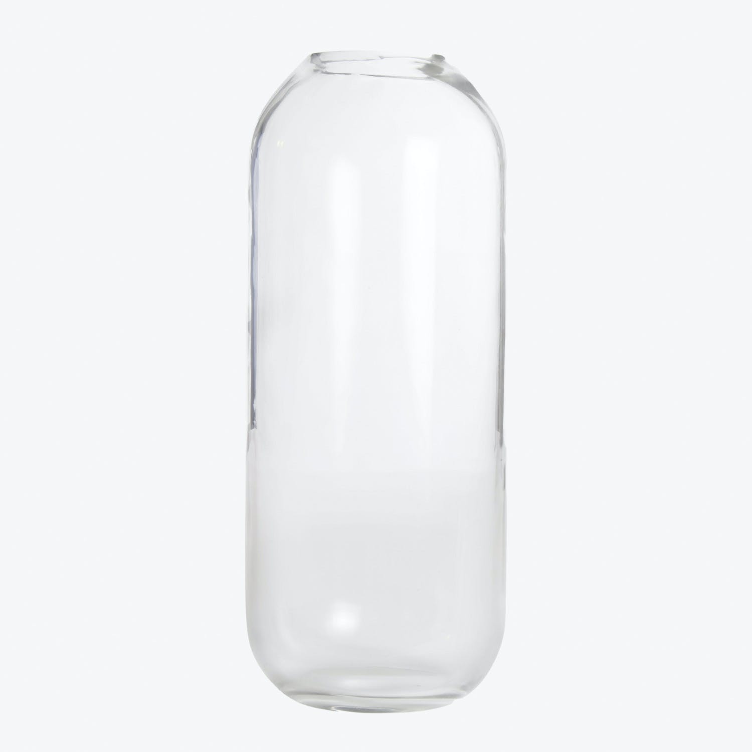 Empty clear glass bottle with smooth surfaces and cylindrical shape.