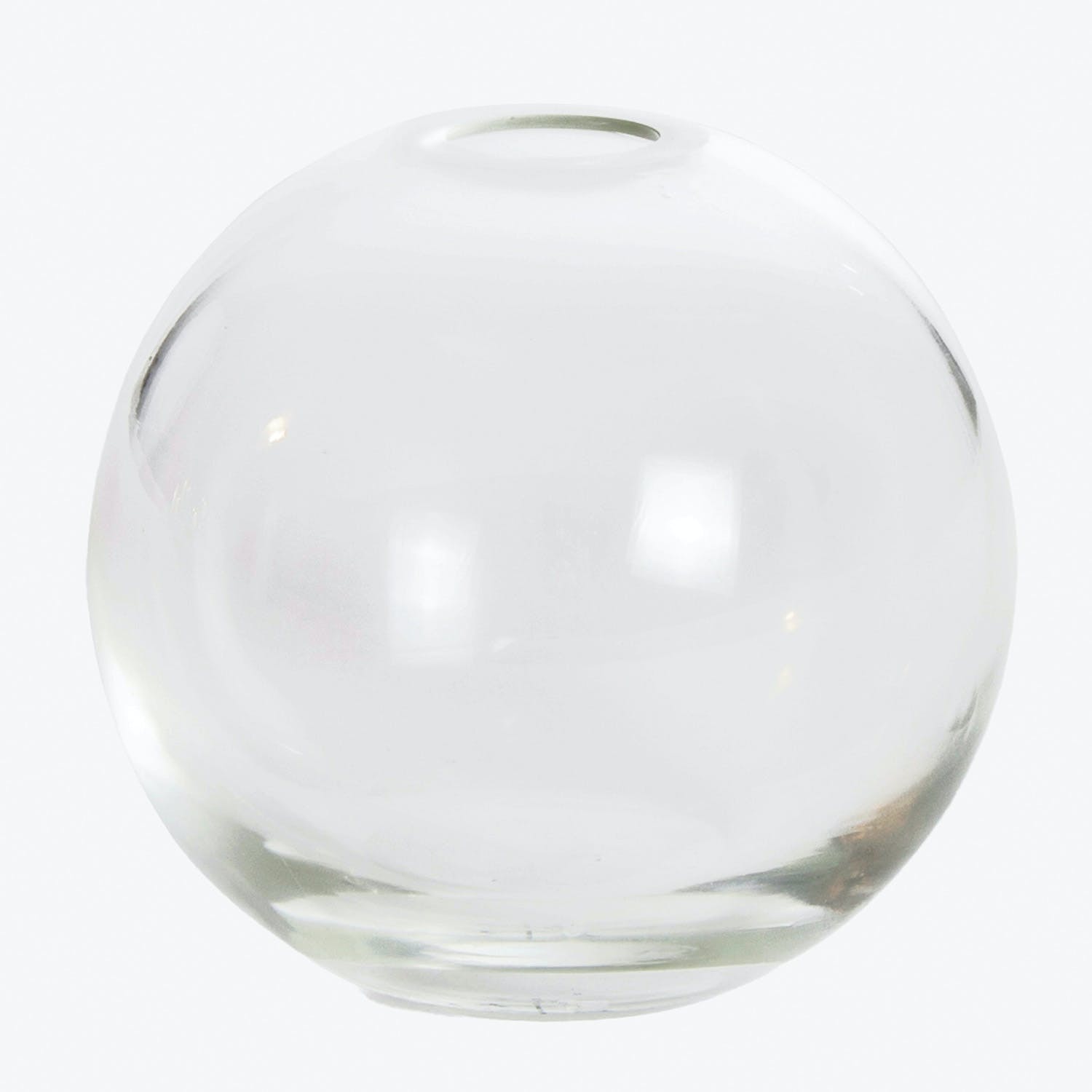 Clear glass sphere with glossy surface and small hole.