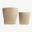 Two woven baskets, different sizes, showcase minimalist craftsmanship and design.