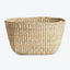 A handwoven straw basket with a traditional tight coil pattern.