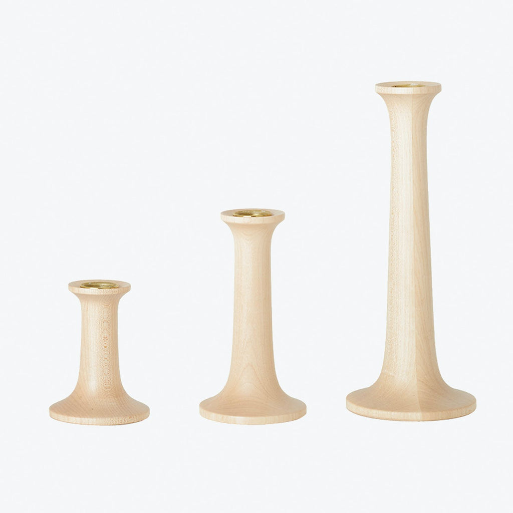 Set of elegant wooden candle holders, varying in height.