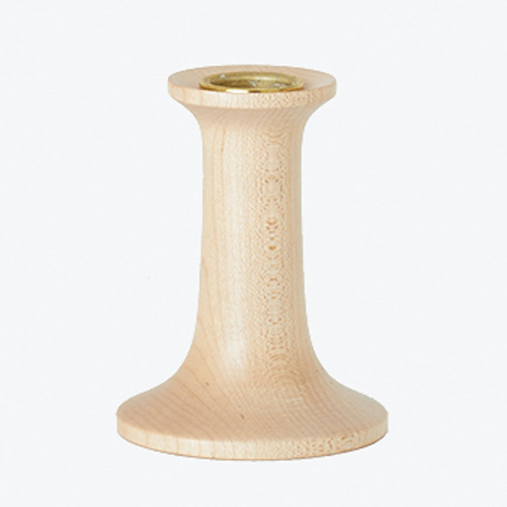 Wooden candle holder with metal insert for secure candle placement.