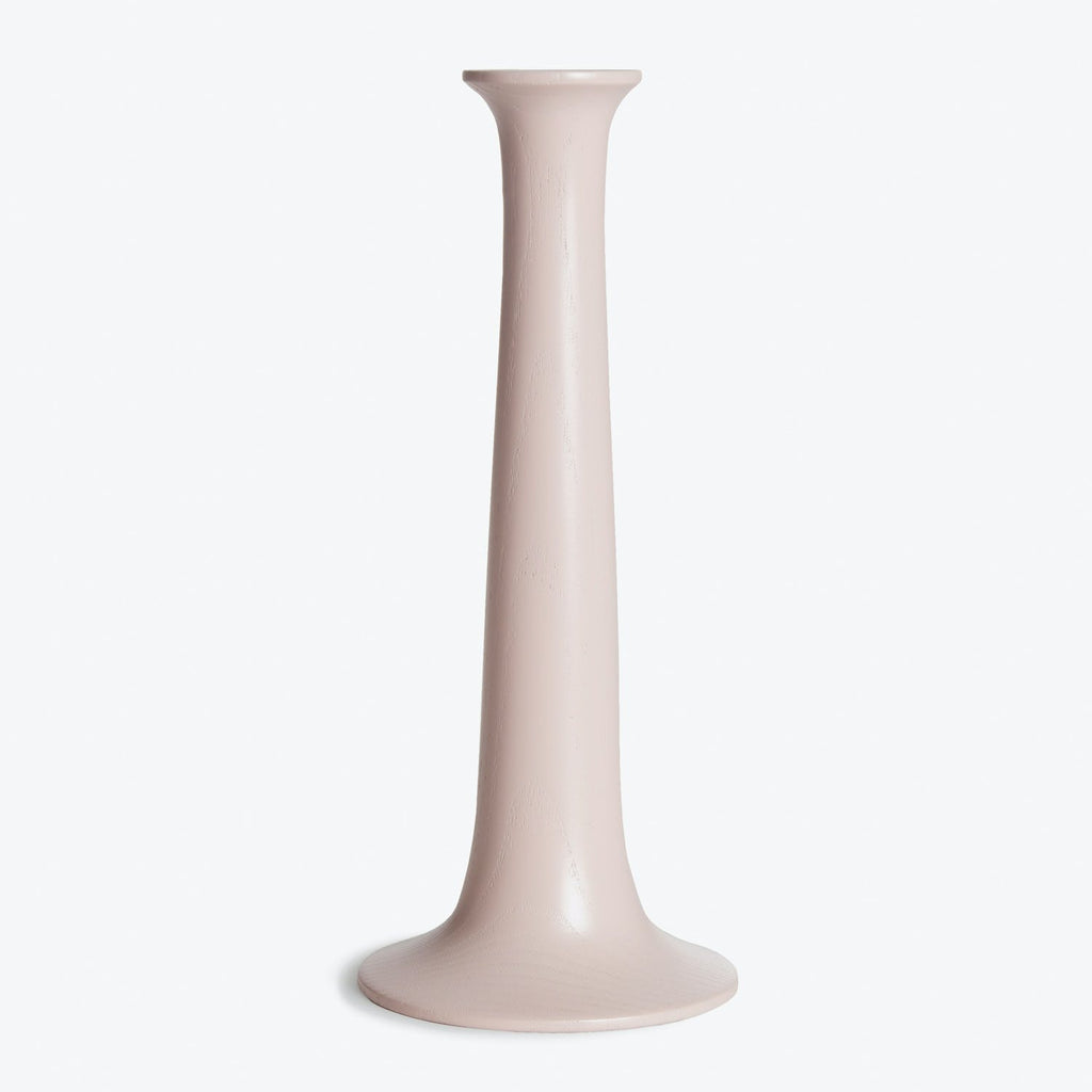 A pale, glossy ceramic vase with a flared opening photographed.