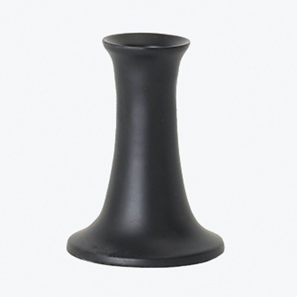 Close-up of a matte black pawn chess piece on gray background.