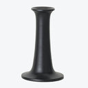Minimalist black candlestick holder with sleek design and matte finish.