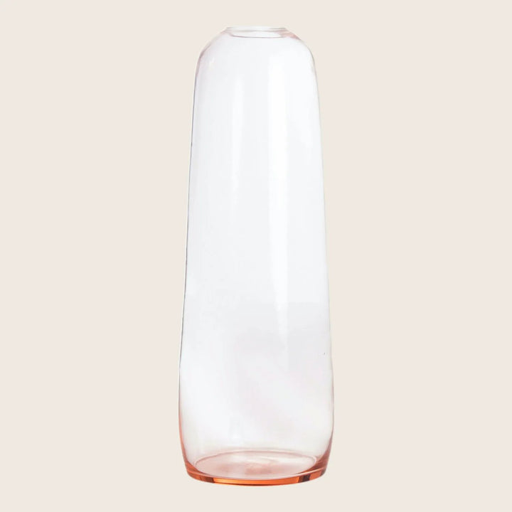 Clear glass vase with pink tinted base displayed against white background.