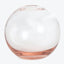 A transparent glass sphere with a pinkish hue at the base.