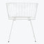 Contemporary white chair with intricate metal design for indoor/outdoor use.