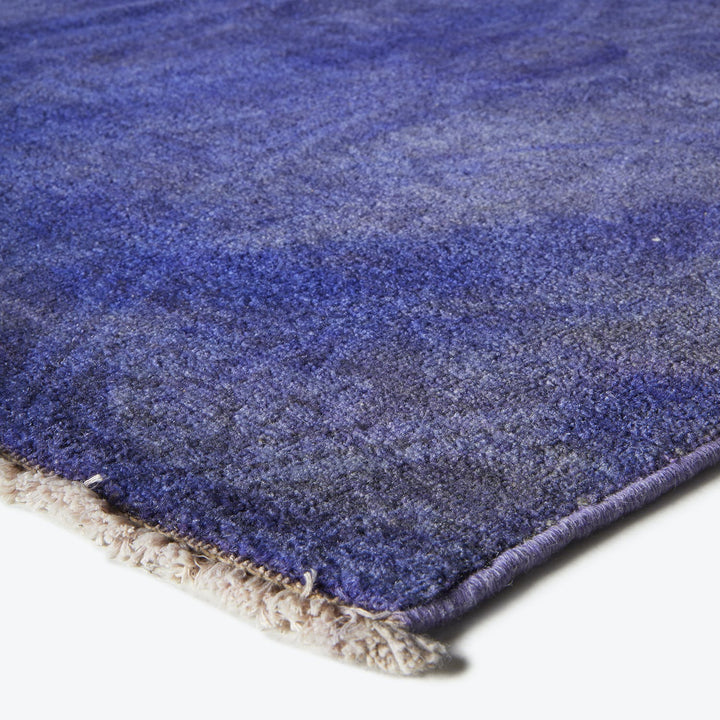Close-up of plush blue rug with gradation of tones.