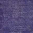 Close-up of a purple fabric with intricate ornate pattern.