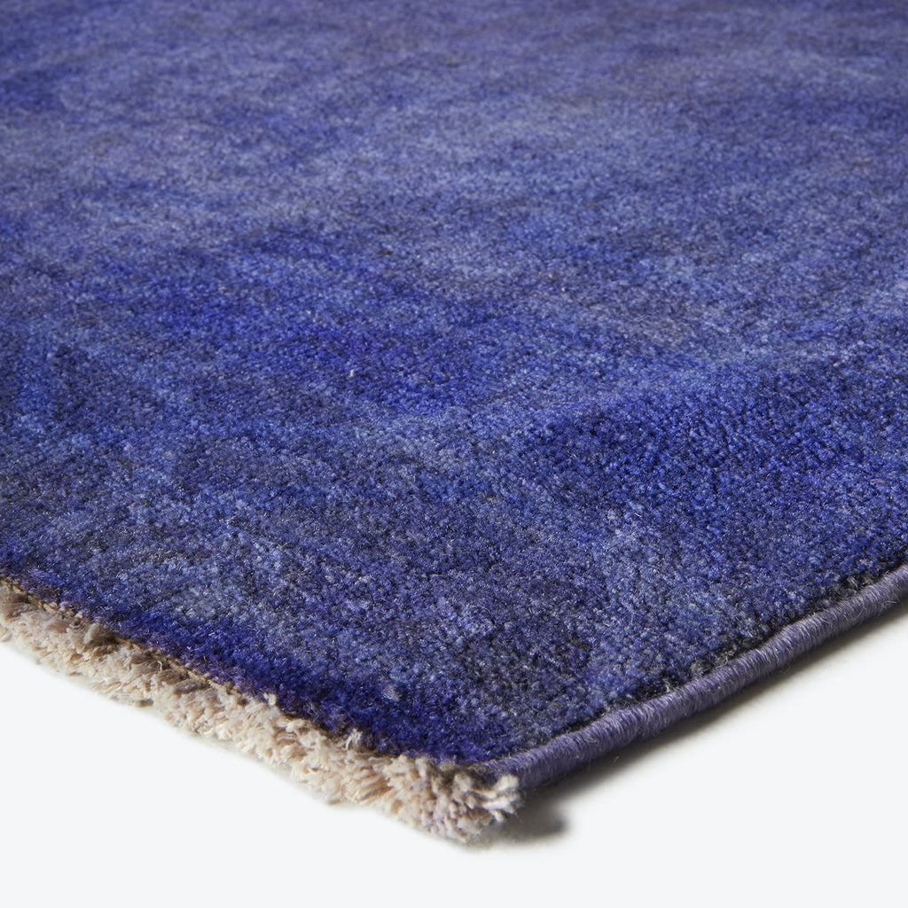 Close-up of a textured blue rug with a soft pile.