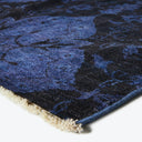 Close-up view of a plush and thick blue carpet rug.