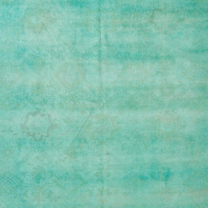 Vintage teal wallpaper with faded floral motifs and distressed texture.