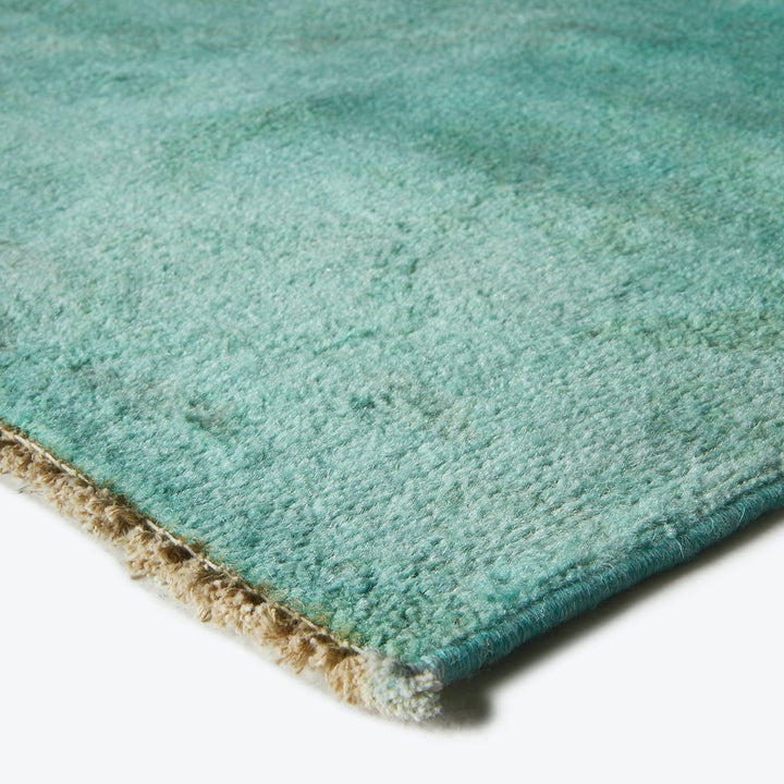 Luxurious teal rug with a plush texture, perfect for home.