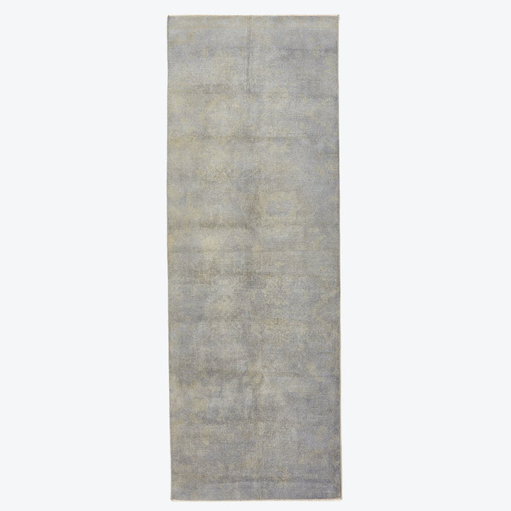Understated elegance: A vintage-inspired runner rug with muted tones.