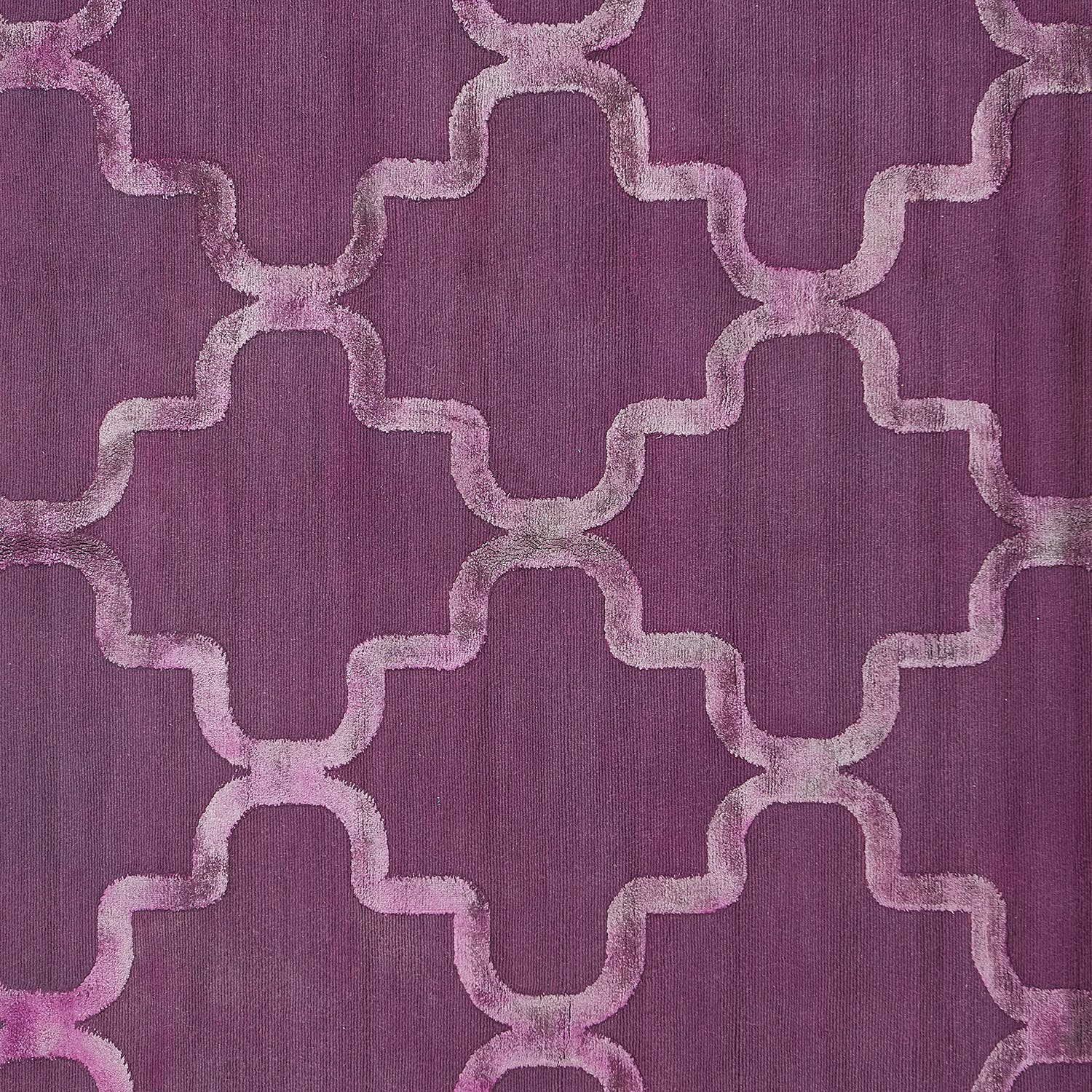 A close-up view of a deep purple fabric with quatrefoil pattern.