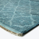 Close-up of a luxurious blue rug with intricate design and texture.