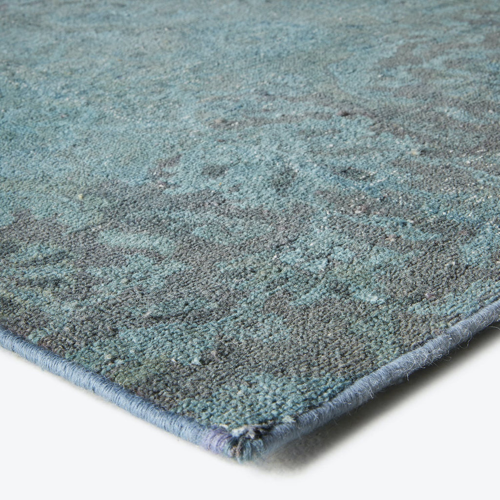 Close-up of luxurious, contemporary rug with soft, mottled blue design.