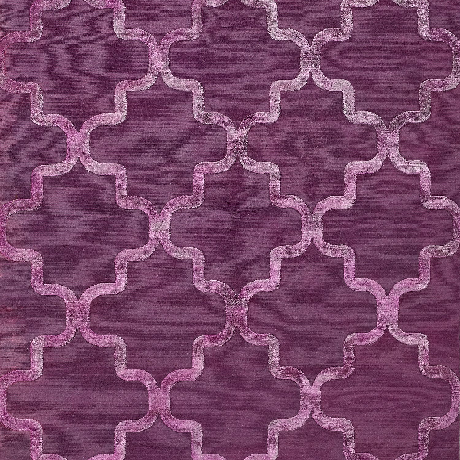 Patterned fabric with geometric design in deep purple, luxurious feel.