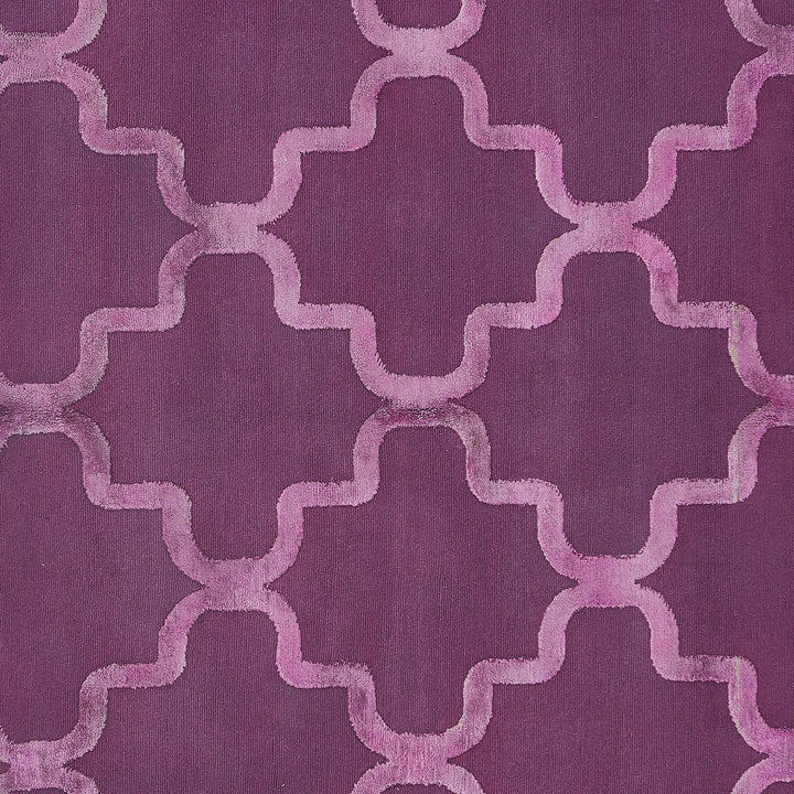 Deep purple fabric with raised, curvy lattice pattern for home decor.